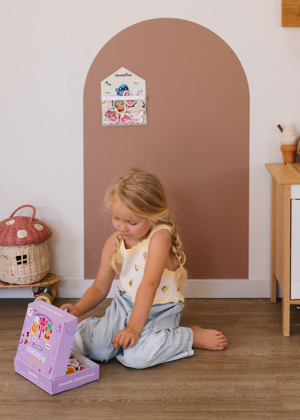 Child playing independently with magnetic toys on a Smartypals play wall