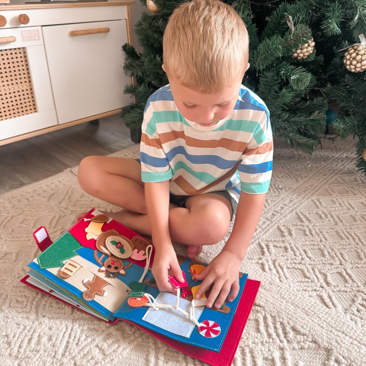 A toddler playing quietly with a SmartyPals felt busy book during quiet time